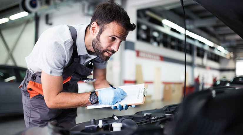 Two technicians inspecting a vehicle at IN'n'OUT Autocentres